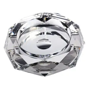 Top view of a faceted crystal candle holder with a circular cavity for a tealight, reflecting light.