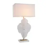 Elegant table lamp with a white rectangular shade and a sculpted glass leaf centerpiece on a gold stem and white base.