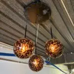 Leopard-print glass pendant lights hanging from the ceiling, glowing warmly.
