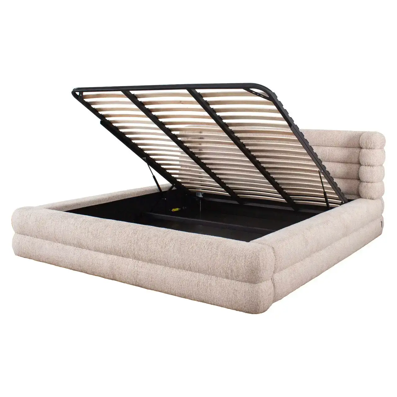 Beige upholstered bed frame with a lifted hydraulic slatted base exposing under-bed storage space