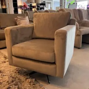 Beige upholstered armchair with straight arms and a back cushion in a furniture showroom.