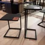 Black metal square-topped nesting tables on display with sale price tag attached to the left table top