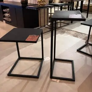 Black metal square-topped nesting tables on display with sale price tag attached to the left table top